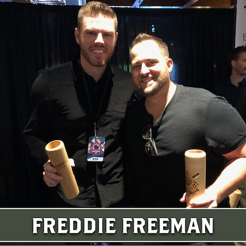 Freddie Freeman posing beside another man, both holding wooden Dugout Mugs baseball bat mugs.